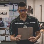 employee looking at notice board in a warehouse office